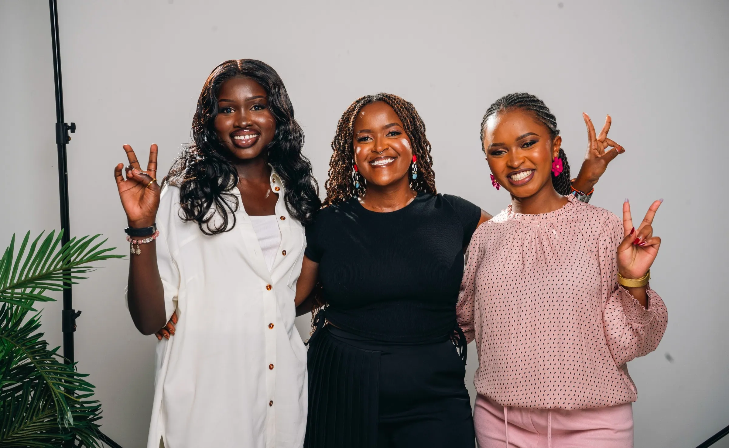 Three TWSS women throwing peace signs in Nairobi