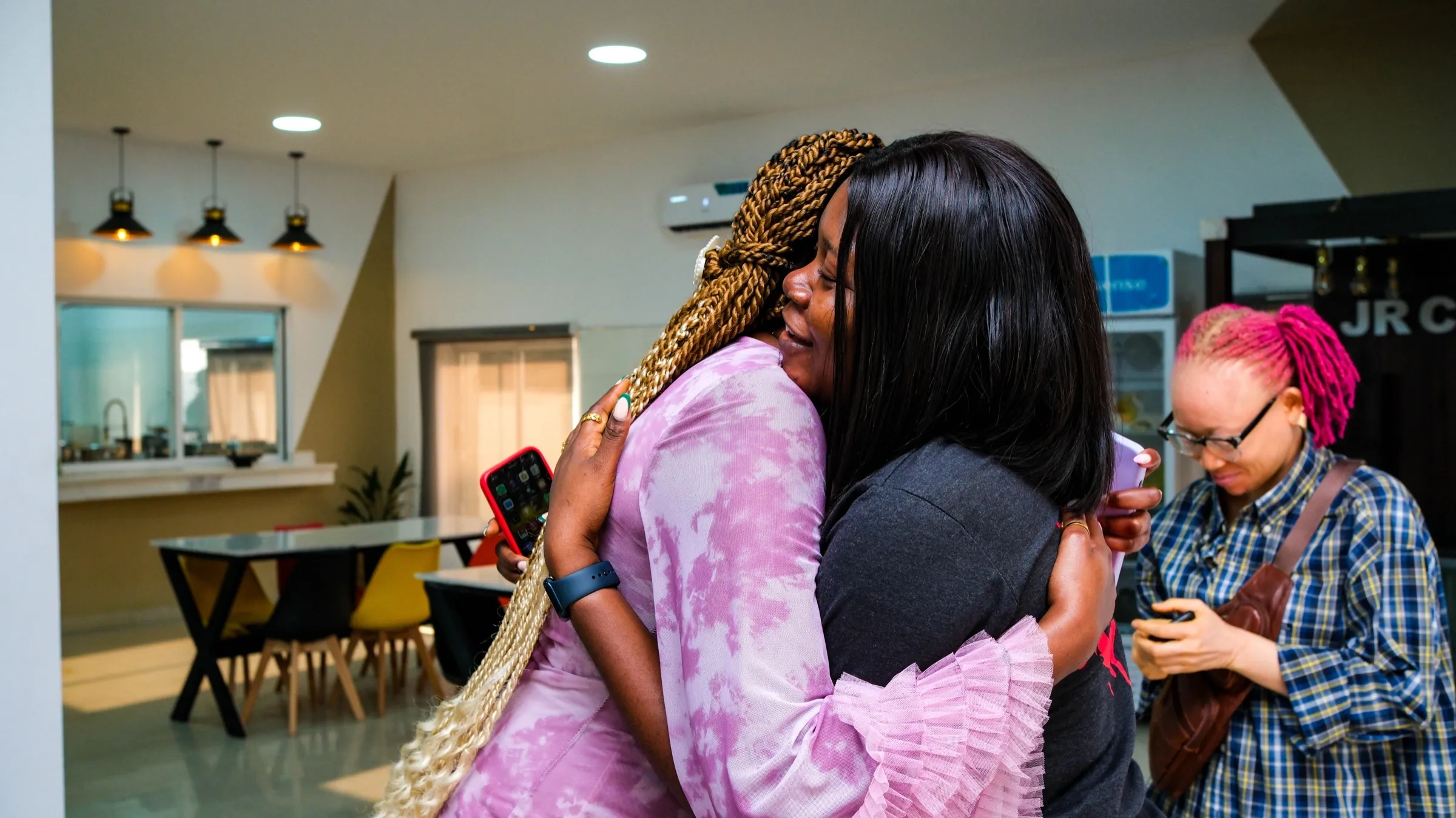 Two TWSS members embracing in Lagos