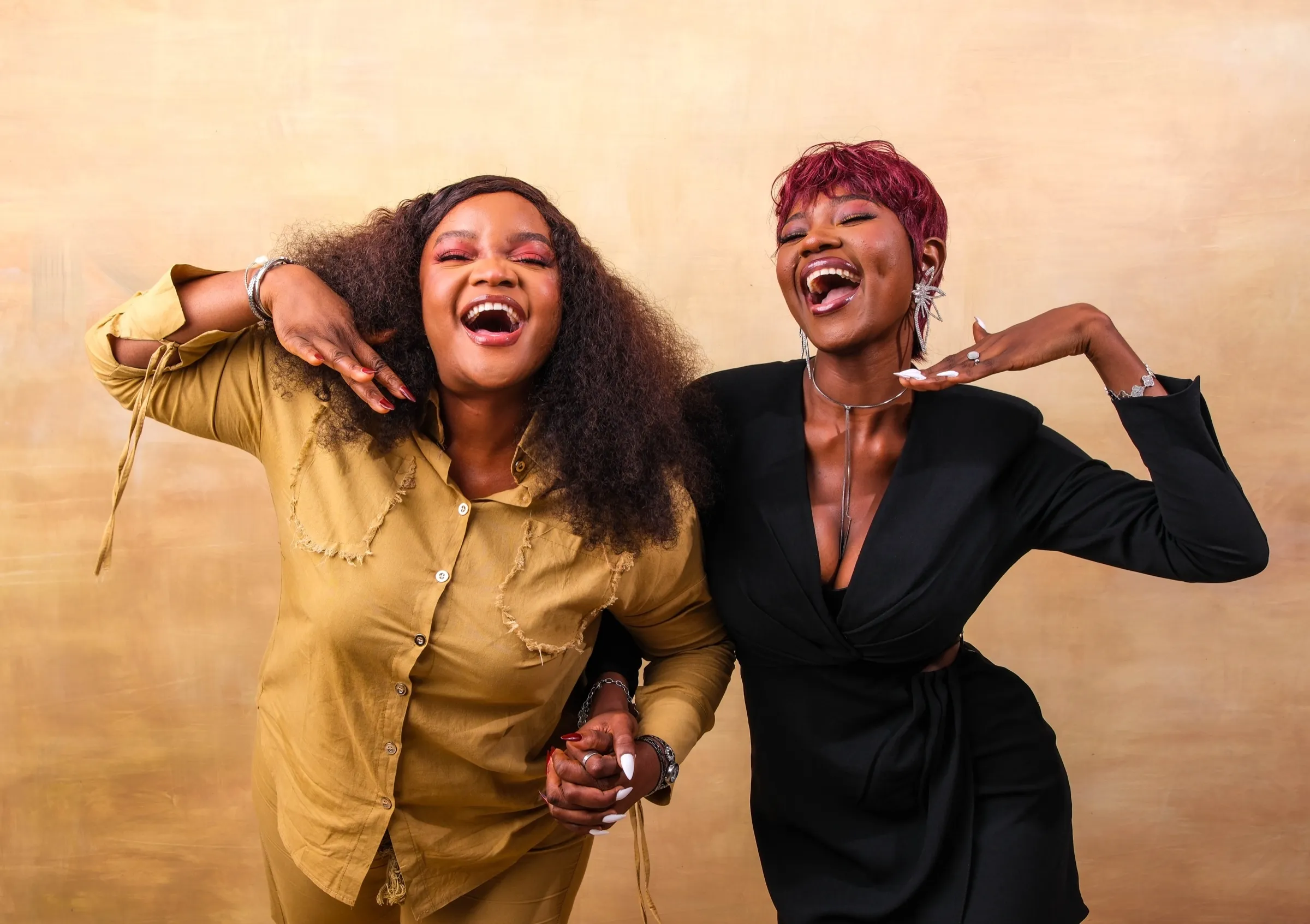 Two TWSS women laughing in a Lagos portrait